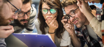 high school students looking at a notepad