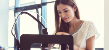 Woman watching polymer 3D printer