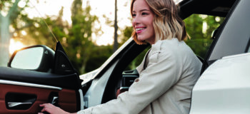 Woman exiting car after her first assisted park