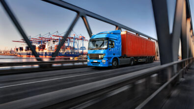 Freight truck leaving a shipping port via a bridge