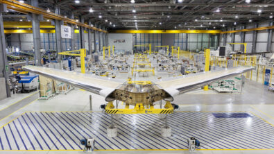 Airplane wings under construction inside a factory.