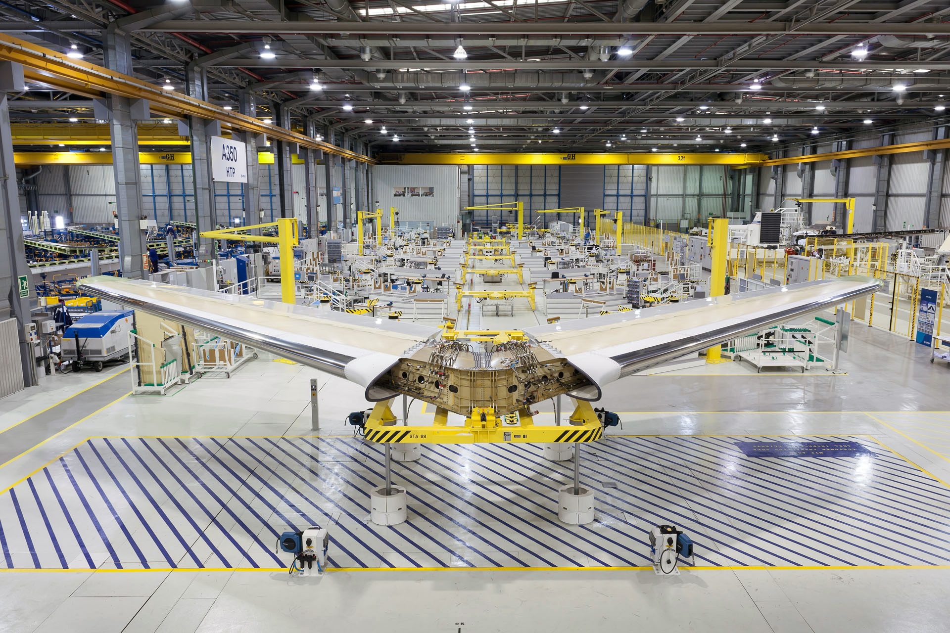 Airplane wings under construction inside a factory.