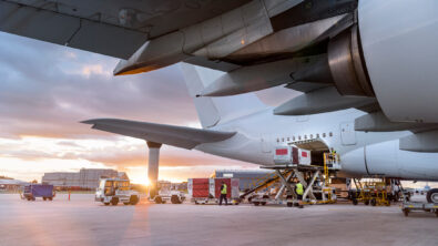 An airplane having its cargo unloaded at an airport.