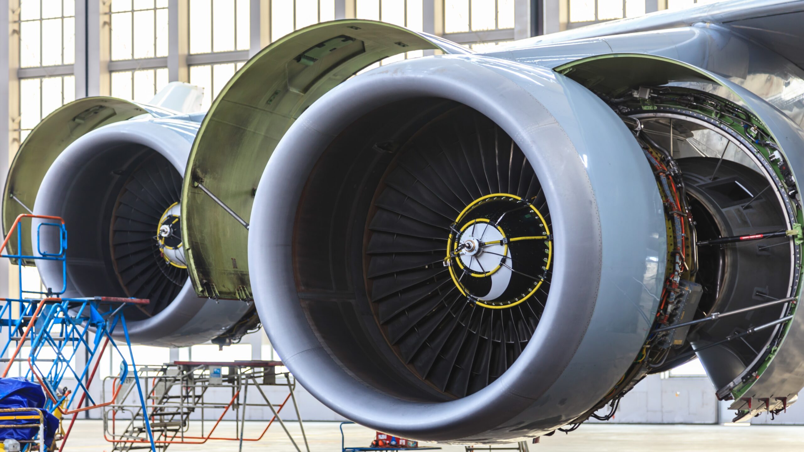 Aircraft engines undergoing maintenance in a hangar.