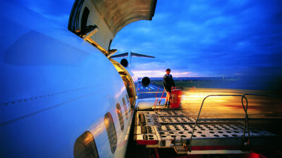 A time-lapsed photo of cargo being offloaded from an airplane.