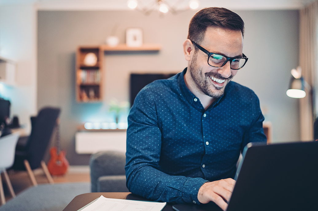 Young man working at home on a laptop