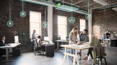 Creative business people meeting at table in open plan loft office