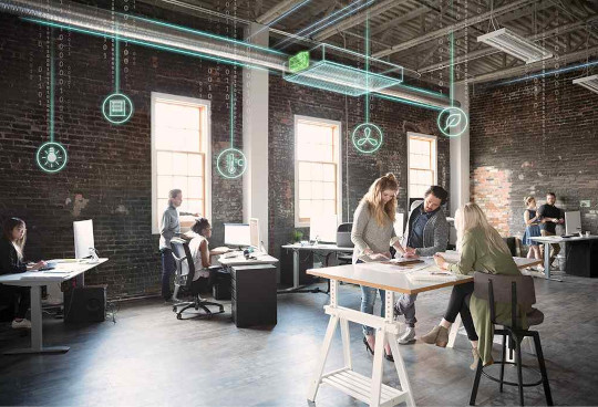 Creative business people meeting at table in open plan loft office