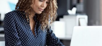 woman typing on a laptop