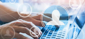 woman typing with digital headshots in circles floating above