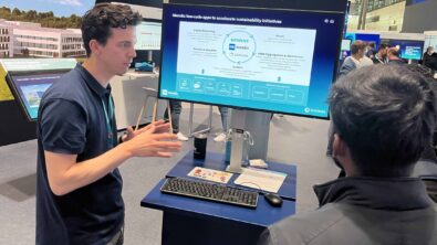 A man explains Sustaira's Sustainability and ESG Circle to an attendee at the Hannover Messe trade fair.