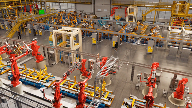 A factory floor of robotic machines is shown from an overhead view.