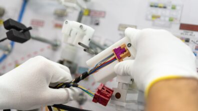 close up of a person assembling wire harness