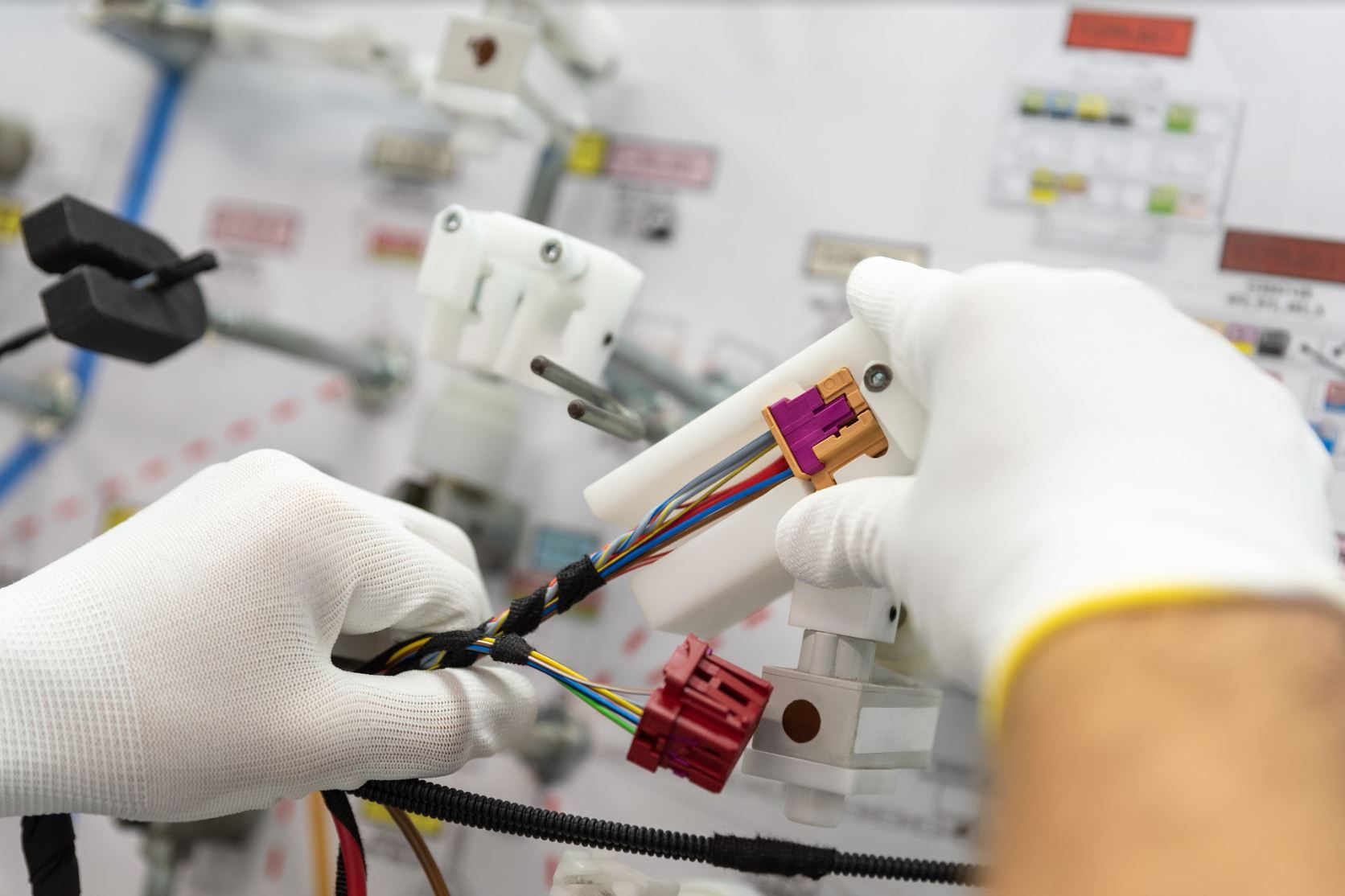 close up of a person assembling wire harness