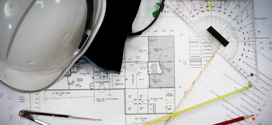 a picture of a table covered with materials for planning a shipbuilding project