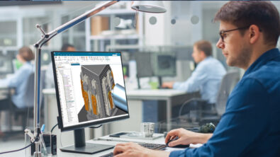 An engineer simulates machine components using simulation software.