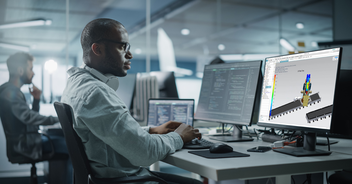 An engineer examines how an industrial machine will operate with simulation tools.