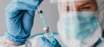 Image of doctor drawing a vaccine through a needle