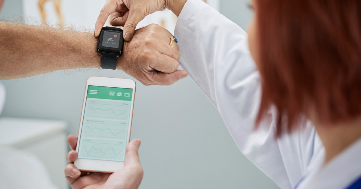 Doctor showing patient how to use smart medical device that connects watch to smart phone.