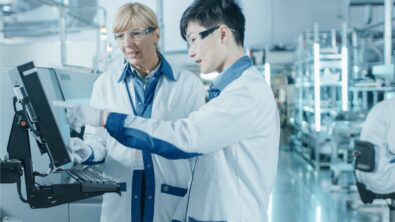 Two scientists looking at a screen in medical device development lab