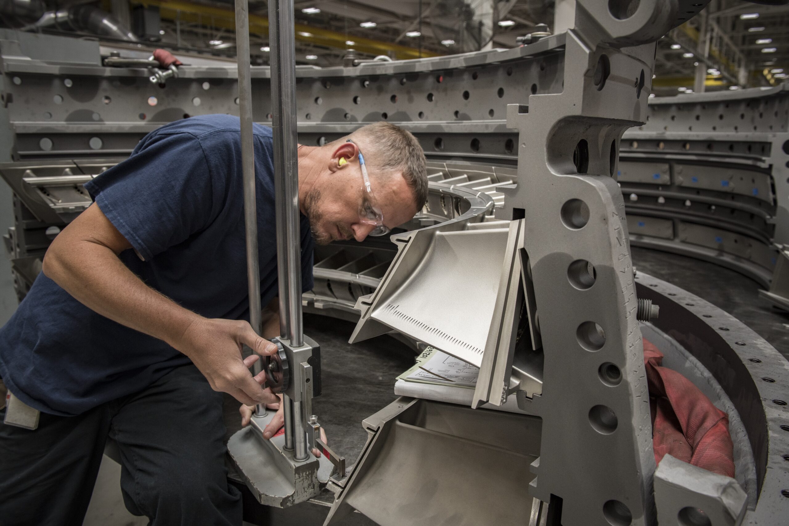 Manufacturing image shows man servicing an asset.