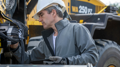 Maintenance technician performing heavy equipment service