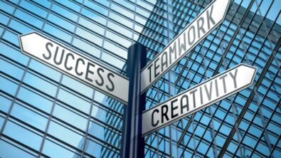 Image of a street sign with three directions. The signs read "Success," "Teamwork," and "Creativitiy"