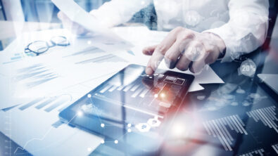 businessman using a tablet--close-up of his hands on the tablet.