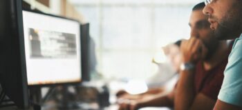 Developers in a row looking at computer screens