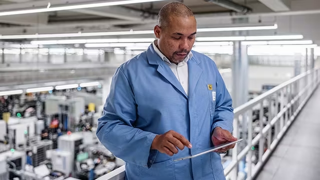 Manufacturing worker using a tablet.