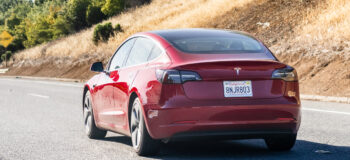 Tesla Model 3 driving on the freeway