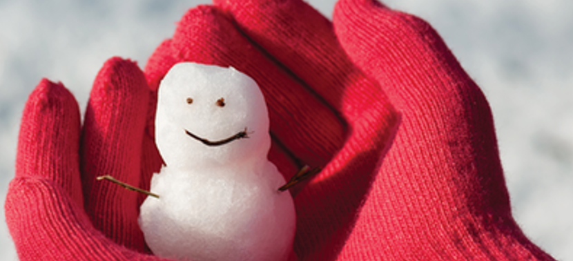 Gloved hands playing in snow.