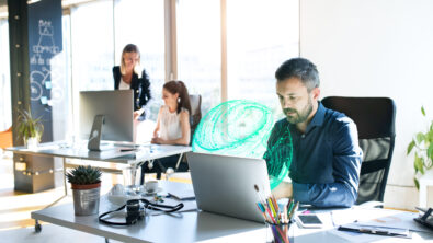 Three business people in the office working together.