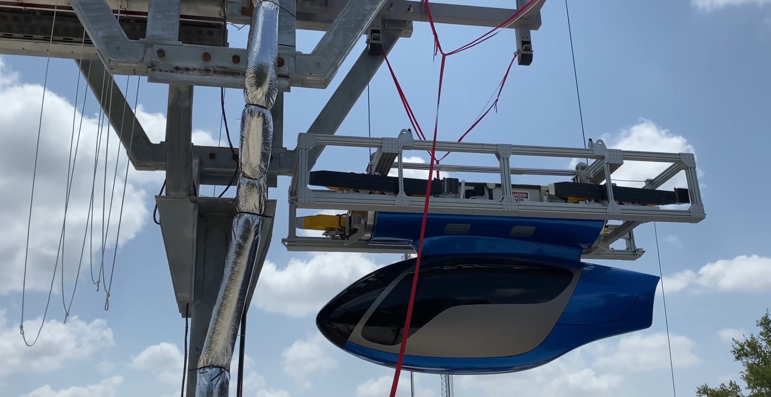 skyTran Pod being raised up to the track, in preparation for a test run