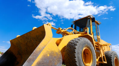 tractor with blue sky and clouds behind it