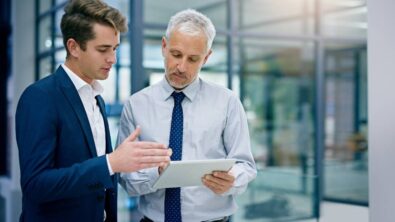 Cropped shot of two businessmen working together on a digital tablet in an office