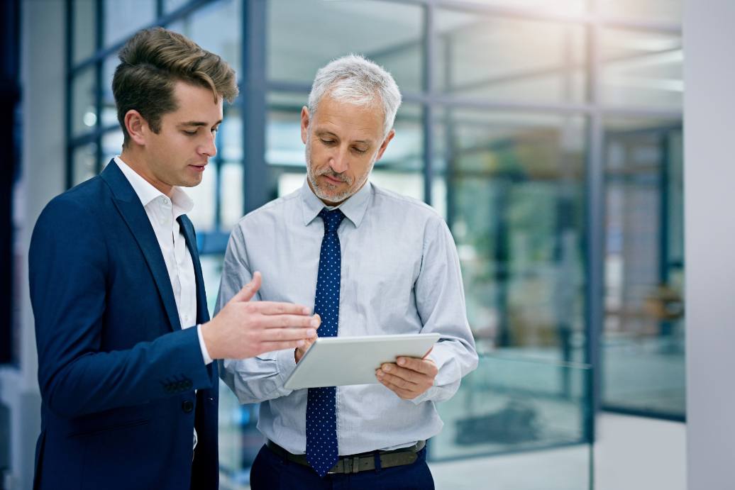 Cropped shot of two businessmen working together on a digital tablet in an office