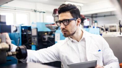 Young engineer holding digital tablet in the factory