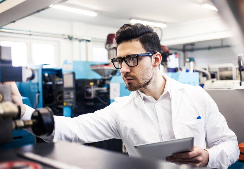 Young engineer holding digital tablet in the factory