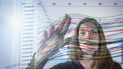 Businesswoman inspecting graph on interactive display