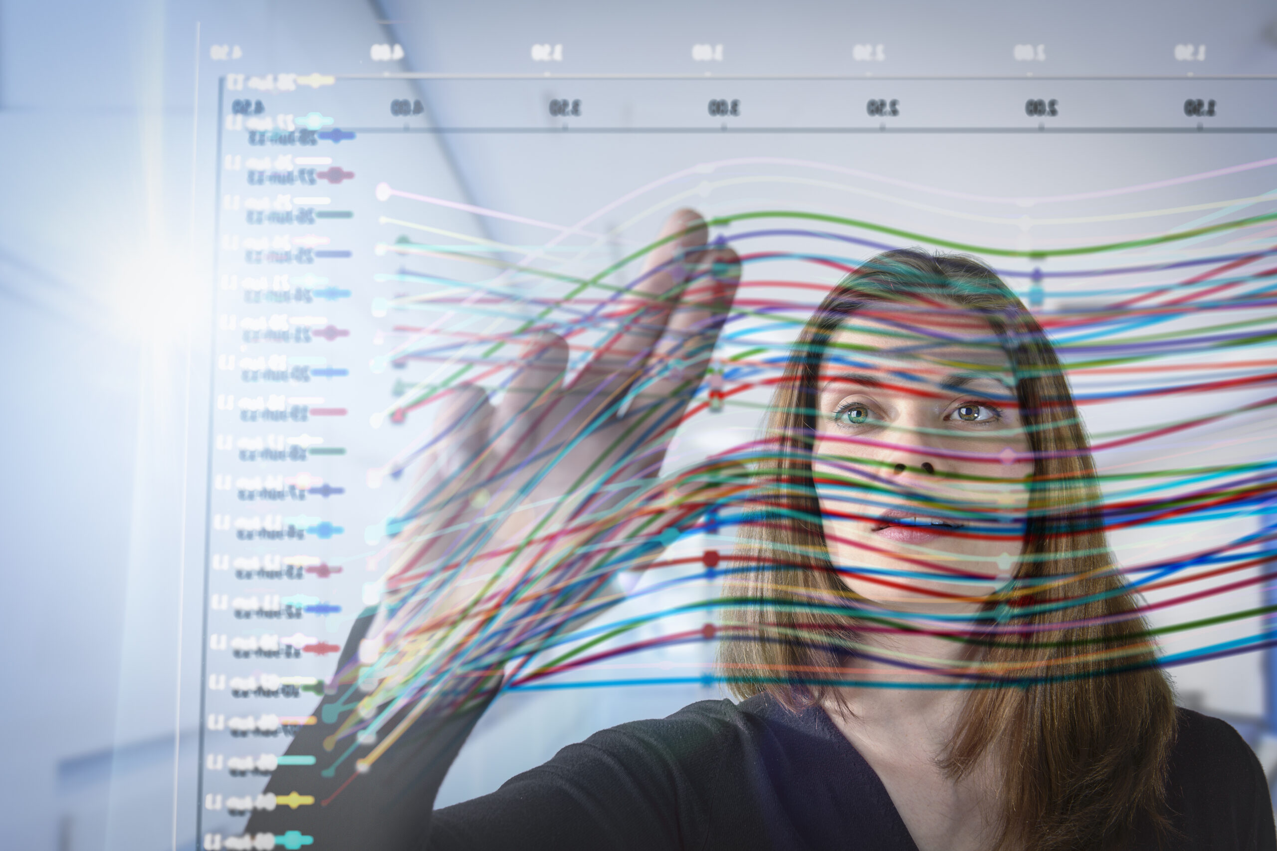 Businesswoman inspecting graph on interactive display