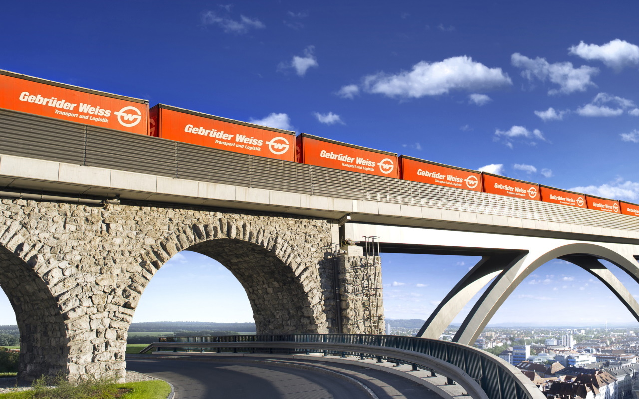 Freight train with containers crosses a bridge