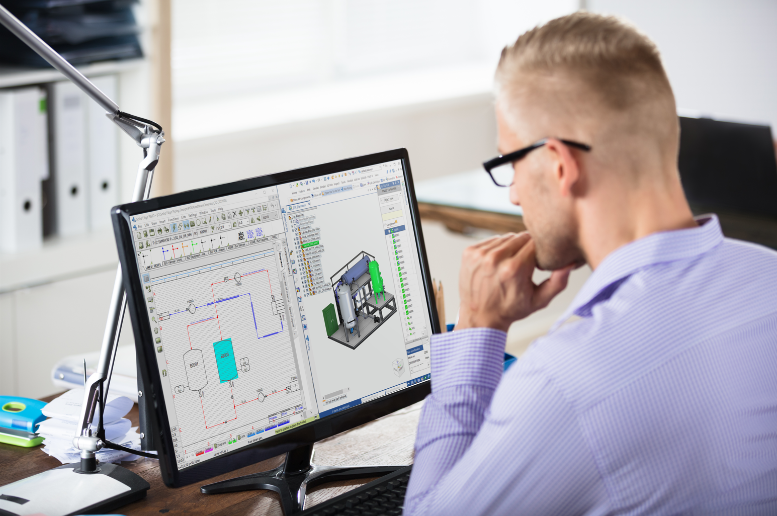 Office worker using Solid Edge P&ID software at their workstation